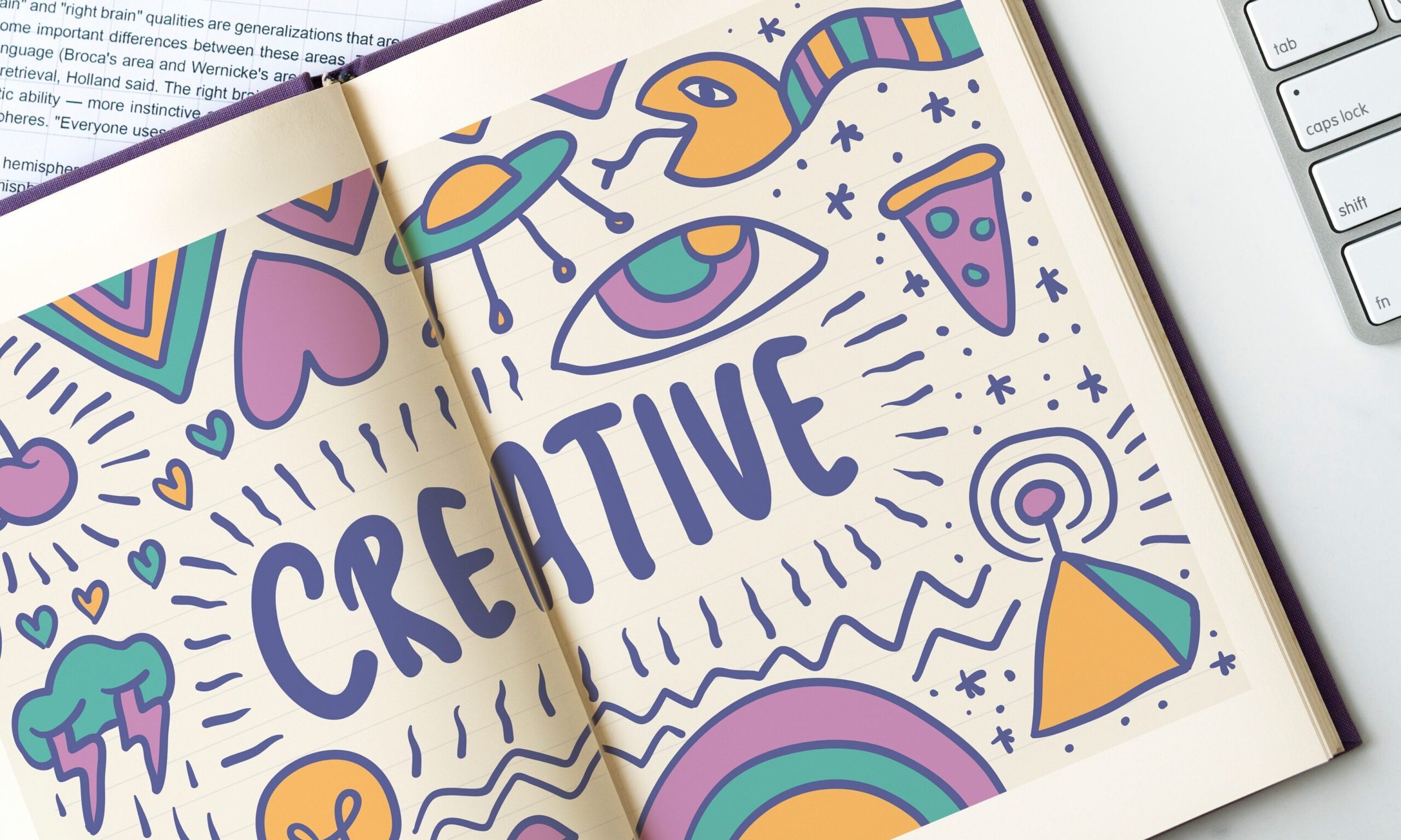 An open book with the word Creative in the center in bright colors