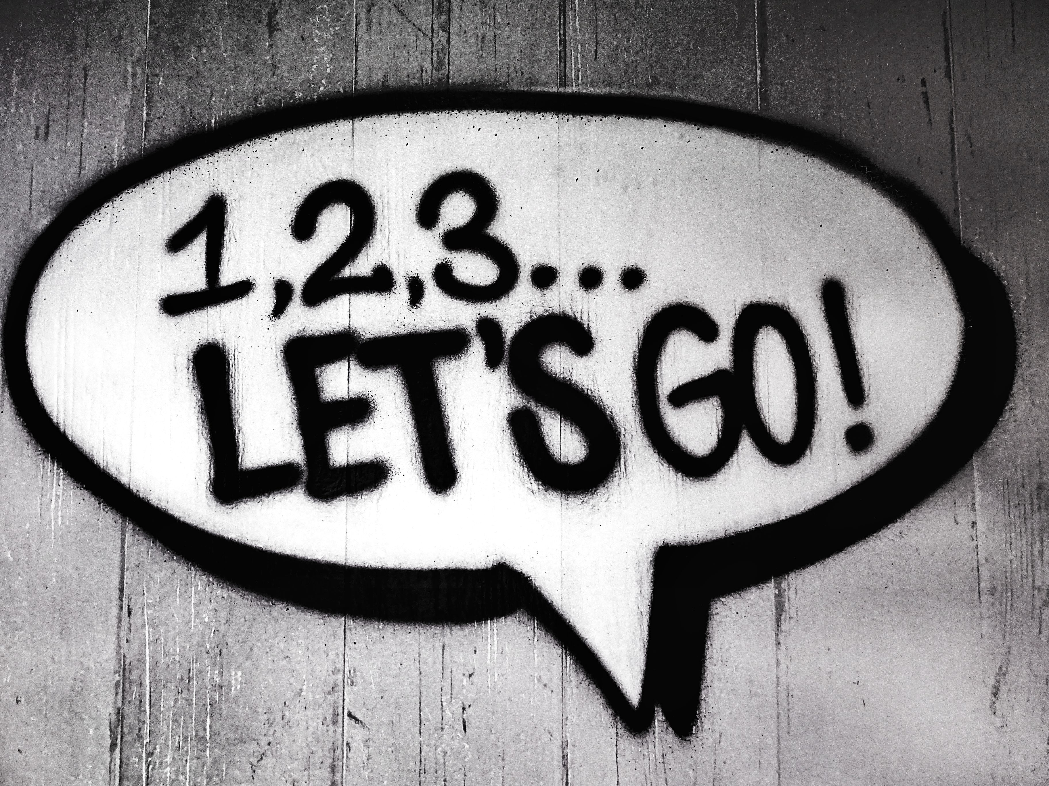 A painted speech bubble that says 1, 2, 3, Let's Go! 